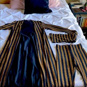 Long gold and black jacket, crop top and pants